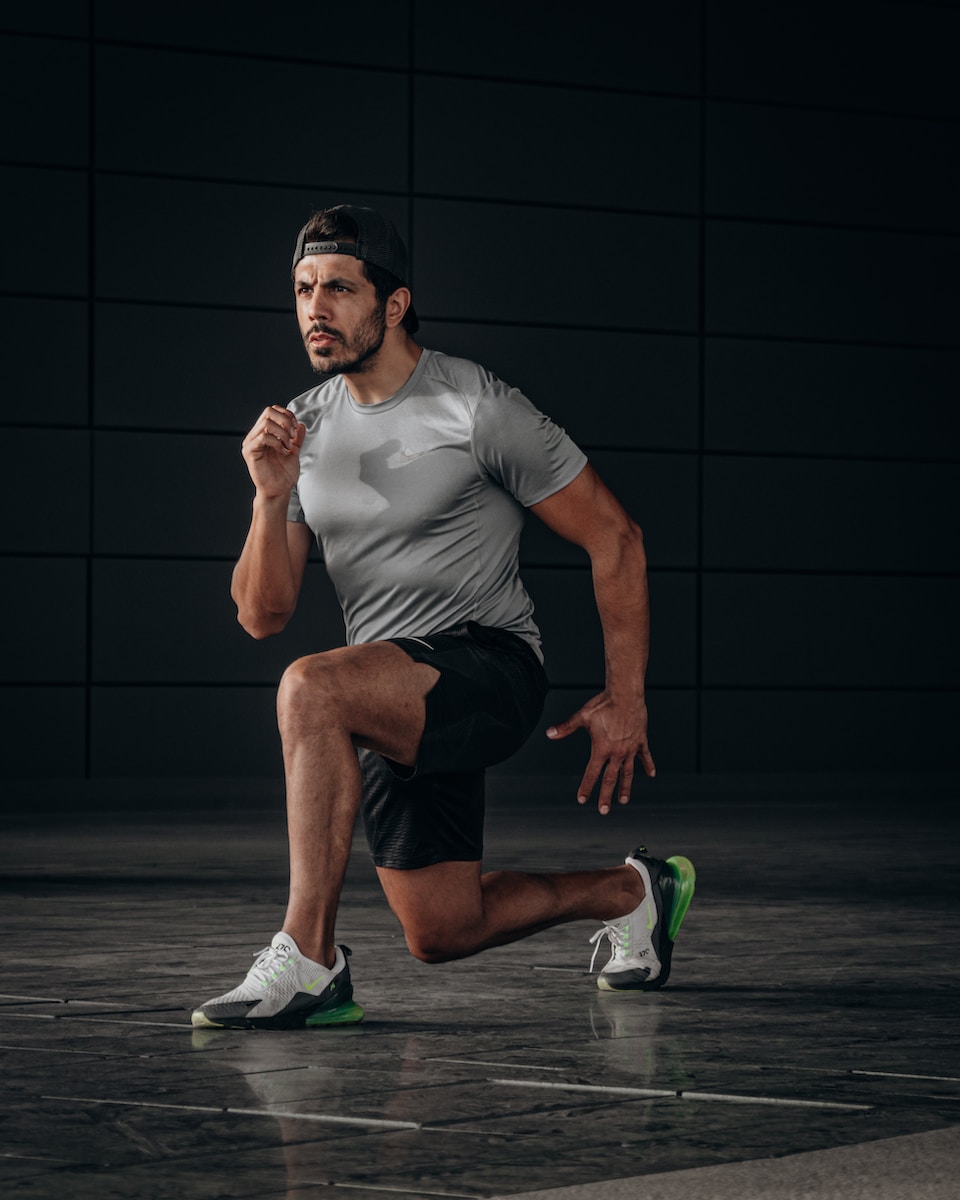 Photo by ÇAĞIN KARGI man in white crew neck t-shirt and black shorts sitting on floor